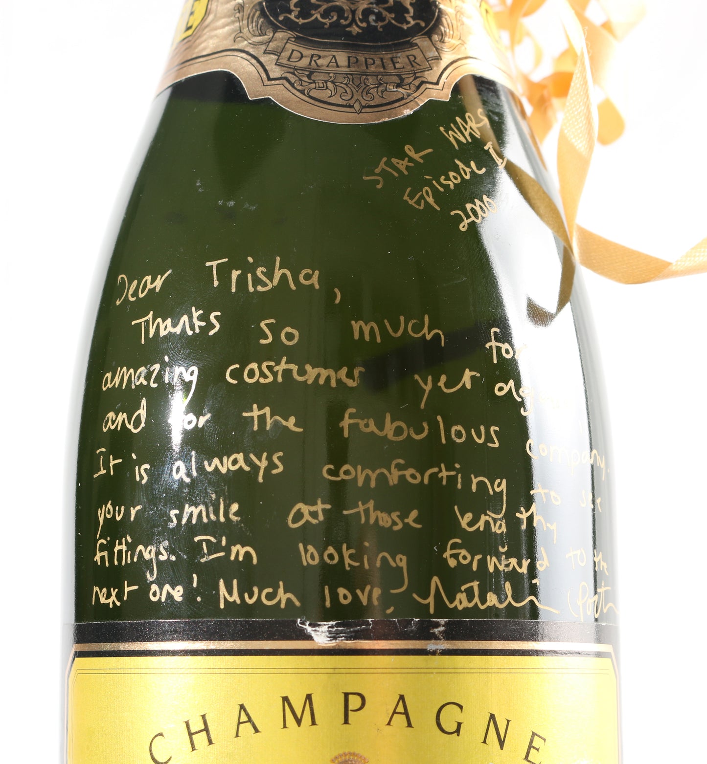 
                  
                    Natalie Portman from Star Wars Episode II: Attack of the Clones Signed Champagne Bottle Gift to Costume designer Trisha Biggar with Personal Thank You Note
                  
                