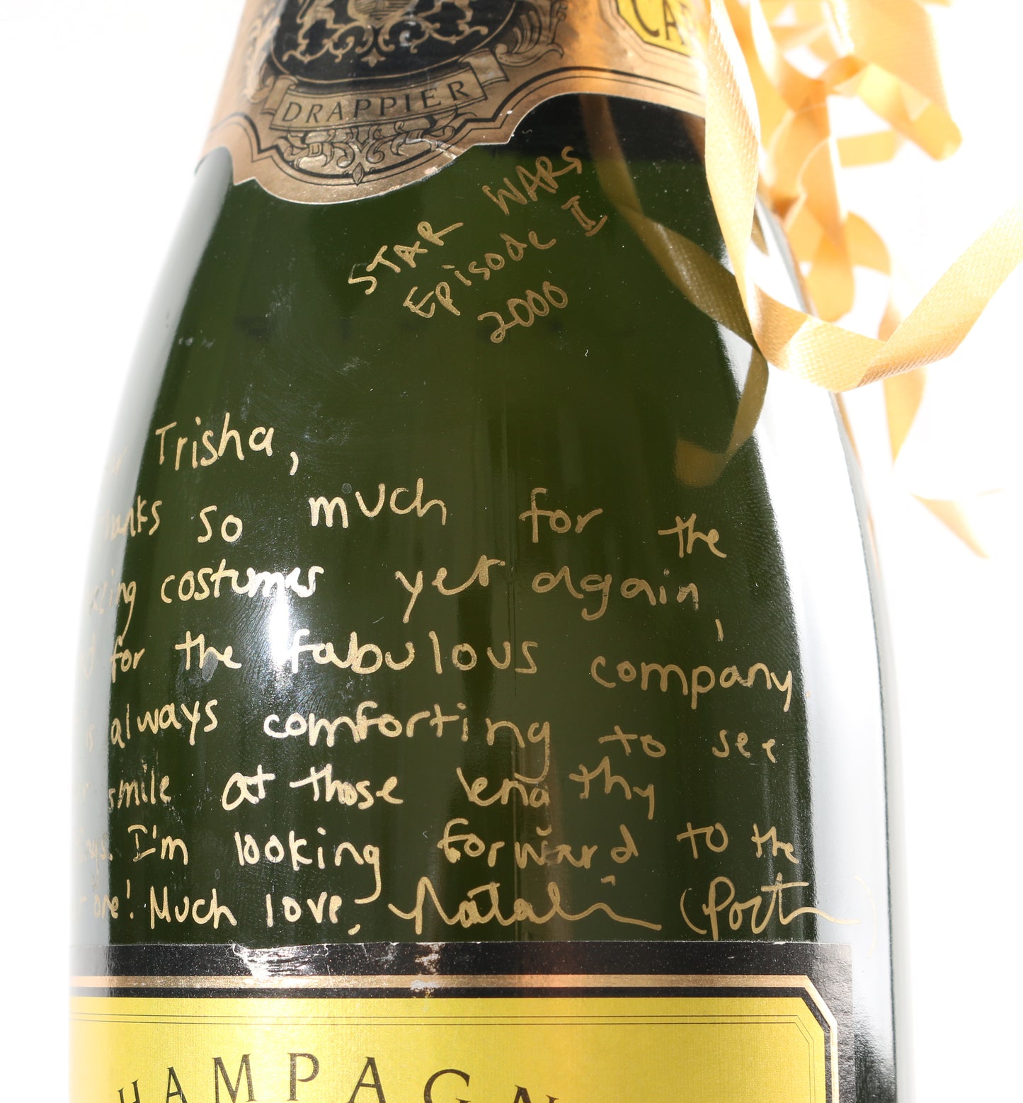 
                  
                    Natalie Portman from Star Wars Episode II: Attack of the Clones Signed Champagne Bottle Gift to Costume designer Trisha Biggar with Personal Thank You Note
                  
                