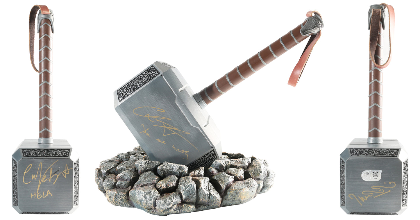 
                  
                    Chris Hemsworth as Thor, Cate Blanchett as Hela, & Taika Waititi as Korg / Director of Thor: Ragnarok (SWAU) Signed Heavy Metal & Leather Prop Replica Mjolnir Hammer with Character Name & Great Quote
                  
                